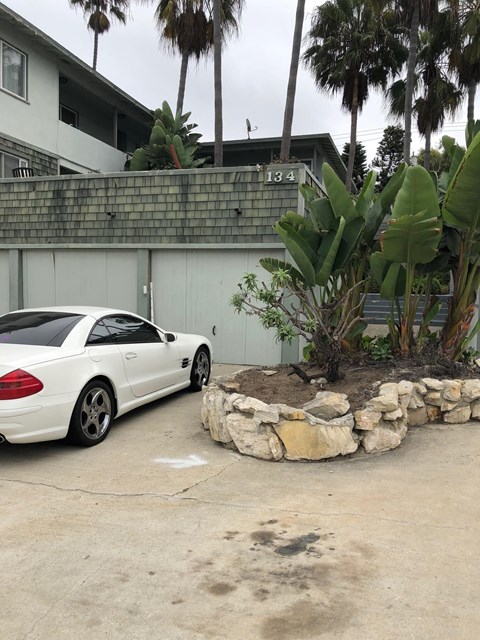 a white car parked in front of a building