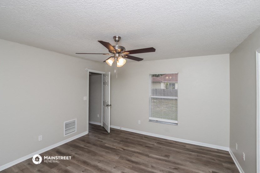 the living room of our studio apartment atrium with ceiling fan and window