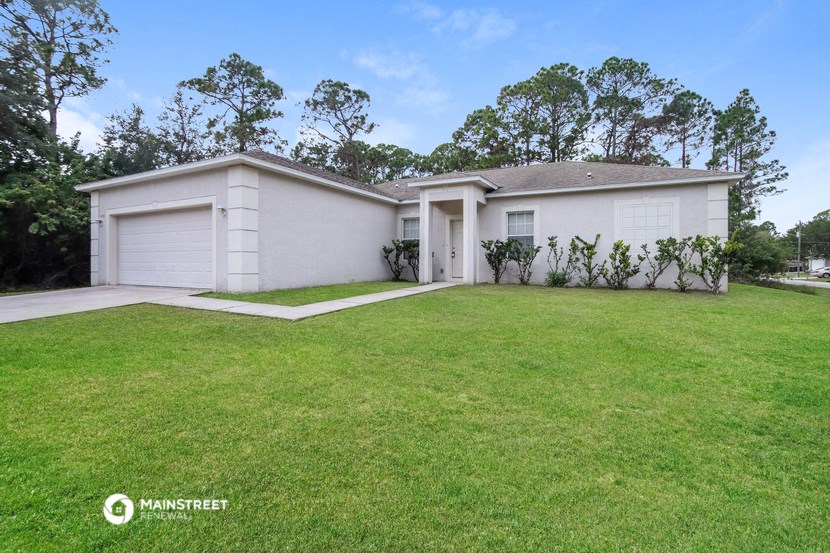 a white house with a lawn in front of it