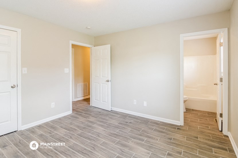 the living room and dining room of a new home with doors open