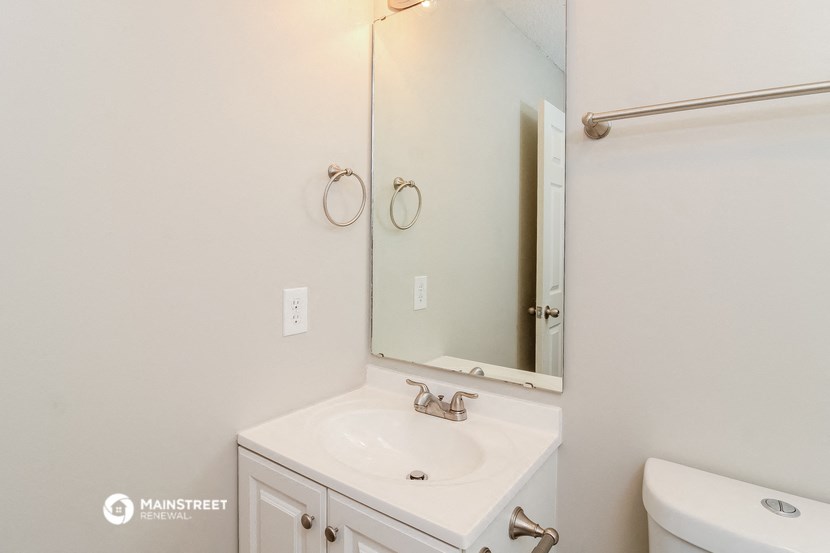 a bathroom with a sink and a mirror and a toilet