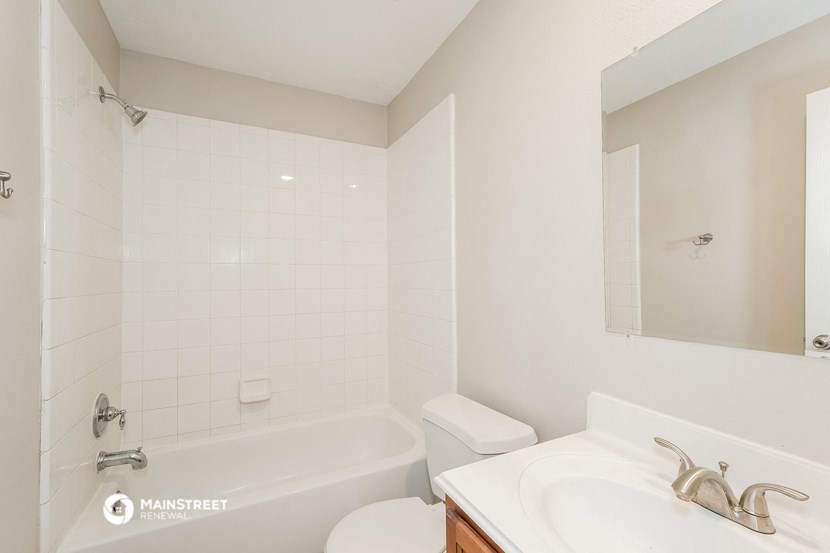 a bathroom with a sink toilet and a tub