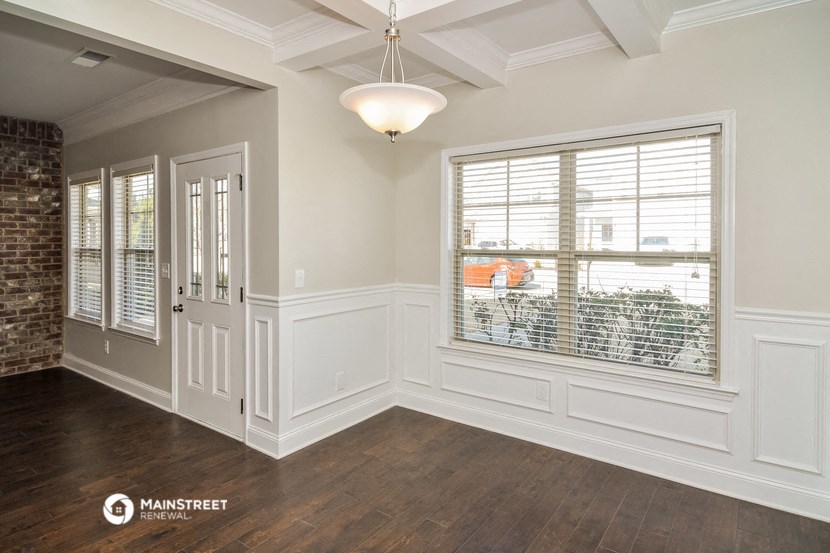 an empty living room with a window and a door