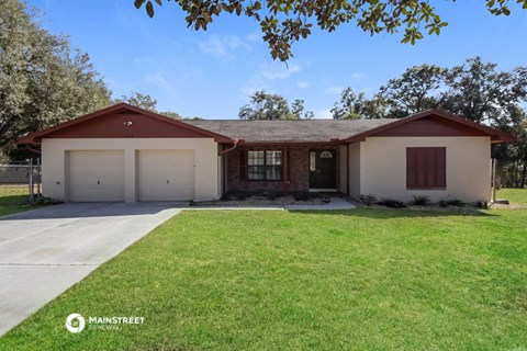 a house with a lawn in front of it and a driveway
