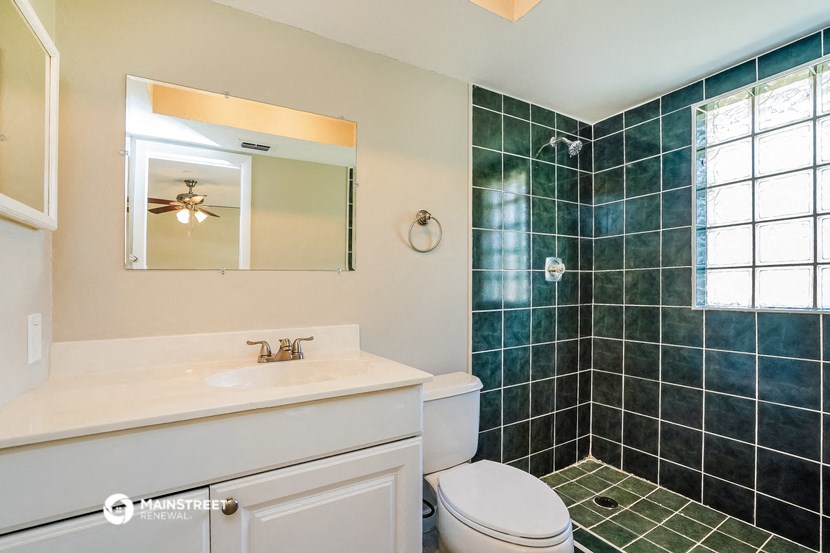 a bathroom with a sink toilet and a shower