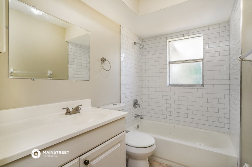 a bathroom with a sink and a toilet and a bath tub