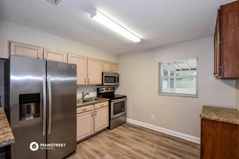 the kitchen of our studio apartment atrium with stainless steel appliances and wooden cabinets