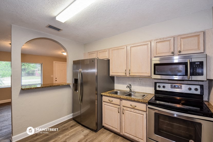 a kitchen with stainless steel appliances and wooden cabinets