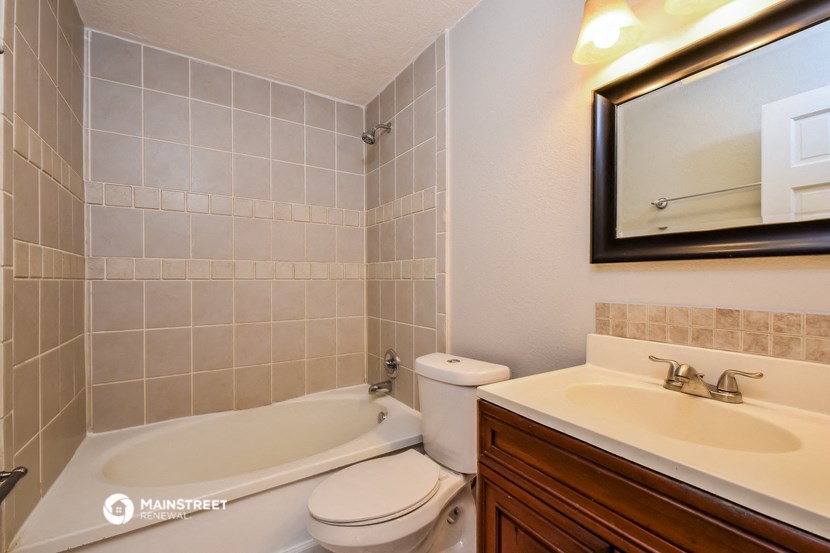 a bathroom with a sink toilet and a bath tub