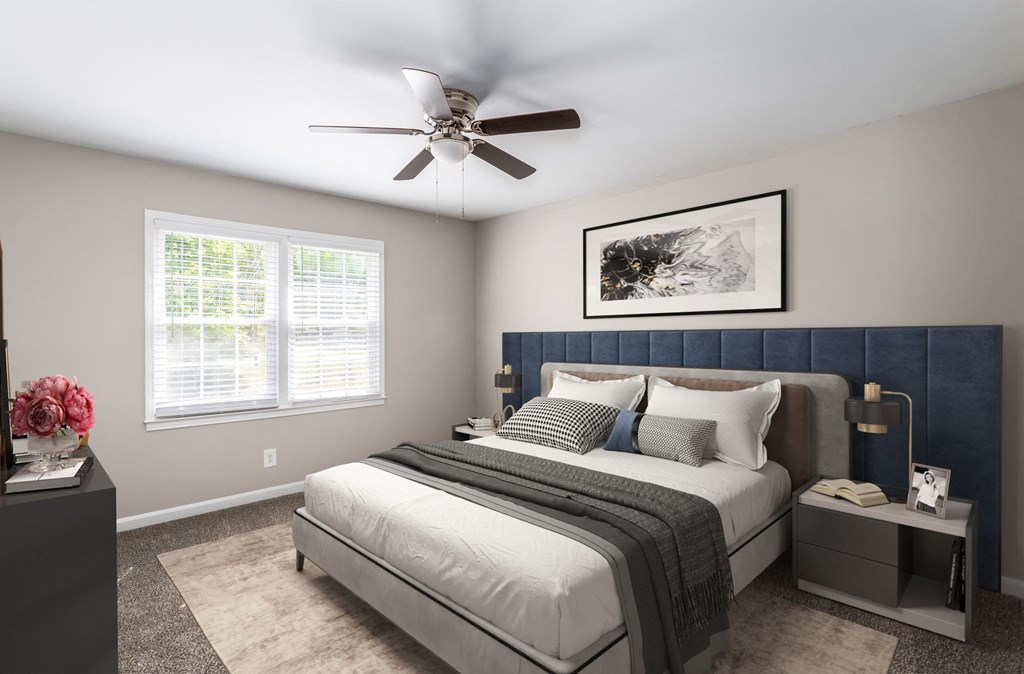 a bedroom with a bed and a ceiling fan