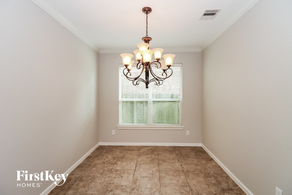 a dining room with a chandelier and a window