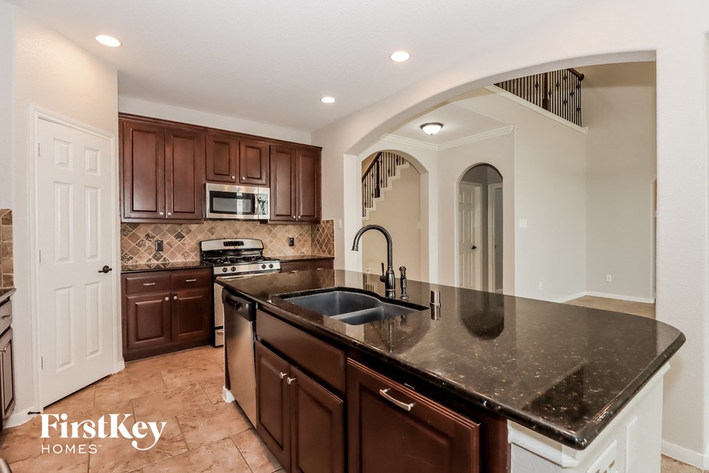 a kitchen with a large counter top and a sink