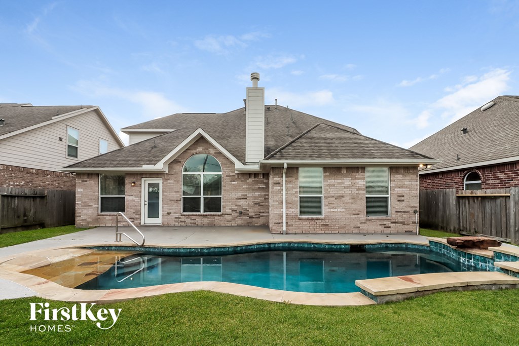 a backyard with a pool and a house