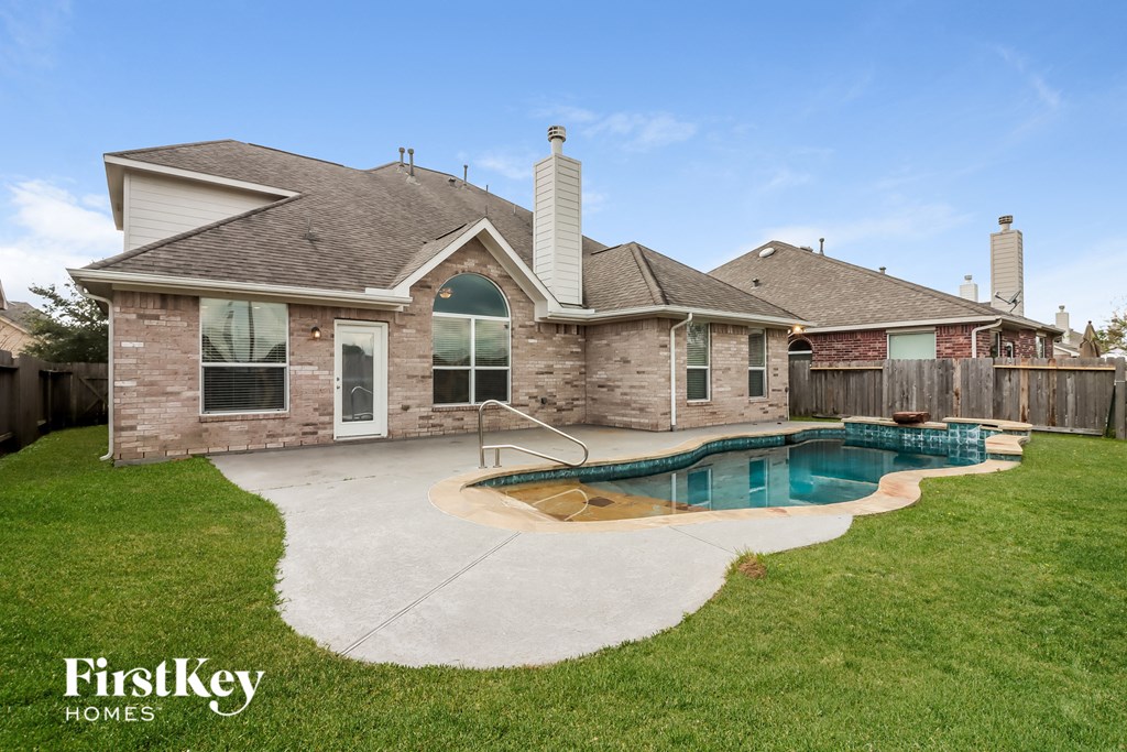 a backyard with a pool and a house