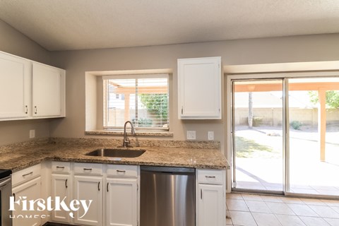 A kitchen with a sink and a window.