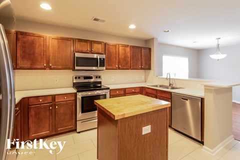A kitchen with wooden cabinets and stainless steel appliances.