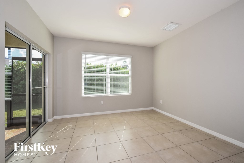 a empty living room with a sliding glass door to a patio