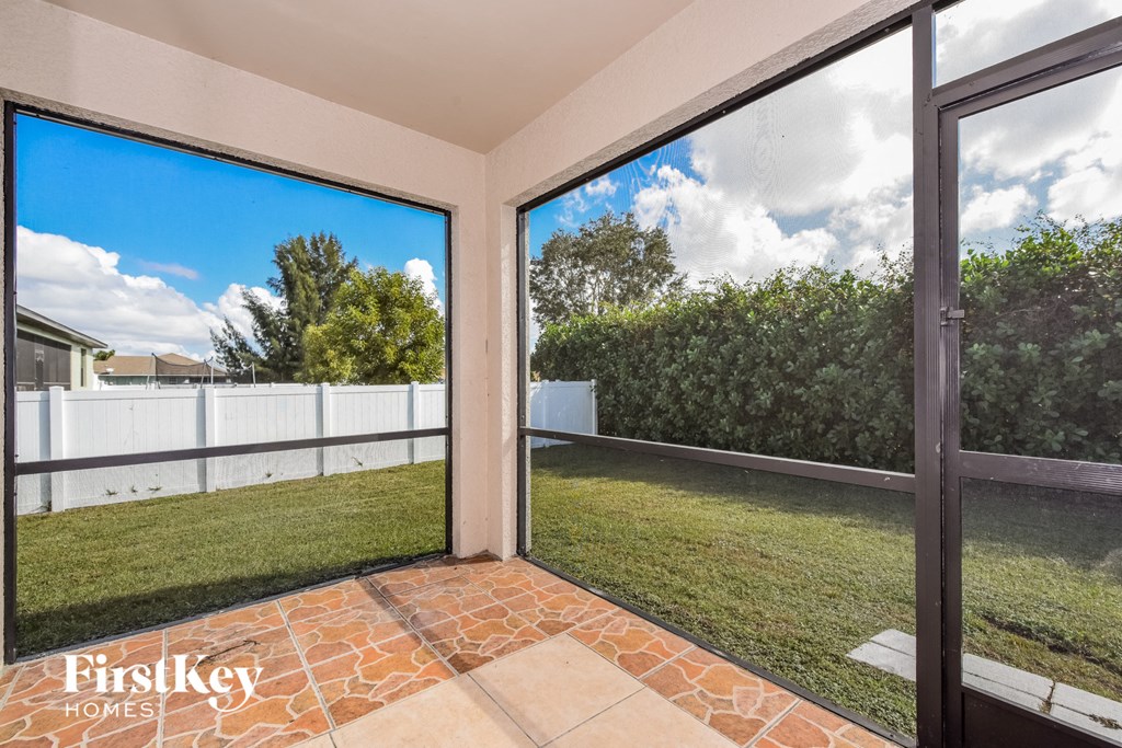 a view of the backyard from the patio doors of a house