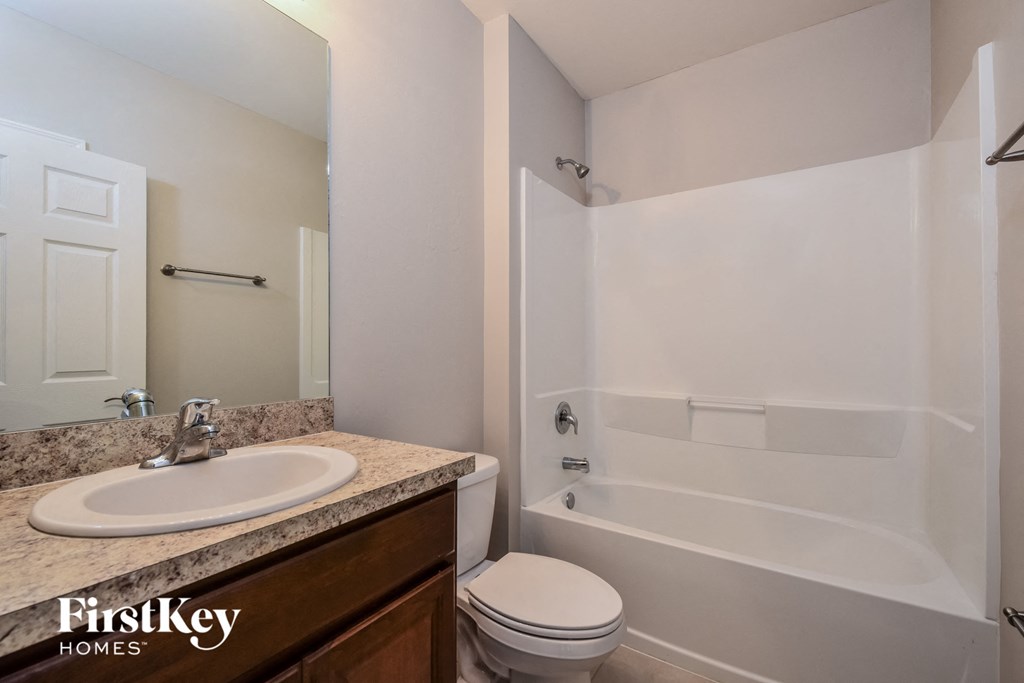 a bathroom with a sink toilet and a shower