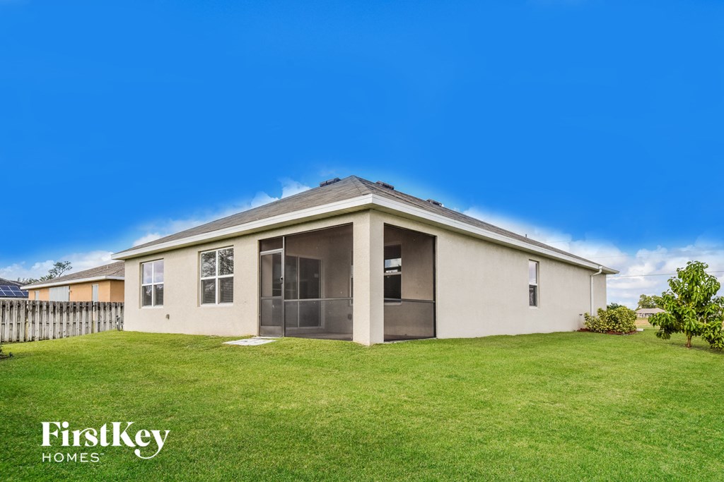 a house with a green lawn and a blue sky