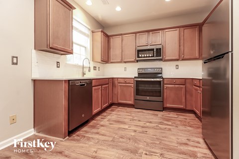 A kitchen with wooden cabinets and stainless steel appliances.