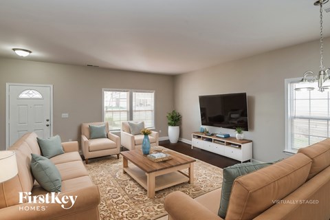 A living room with a brown couch and a wooden coffee table.