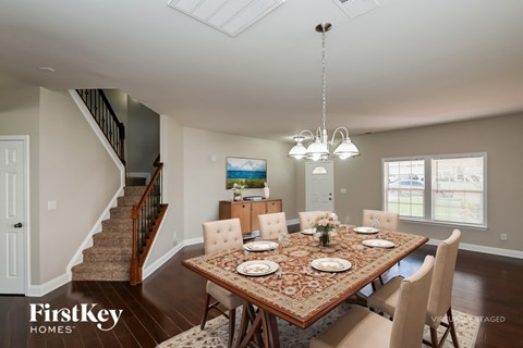 A dining room with a table set for six.