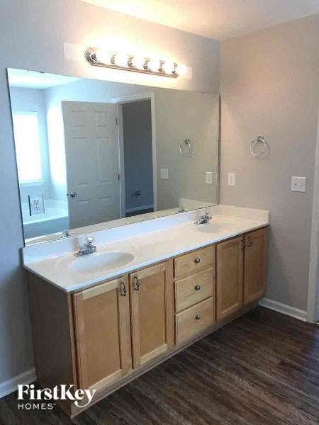 a bathroom with two sinks and a large mirror