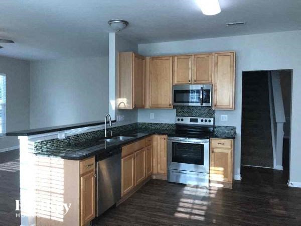 a kitchen with a stove and a sink