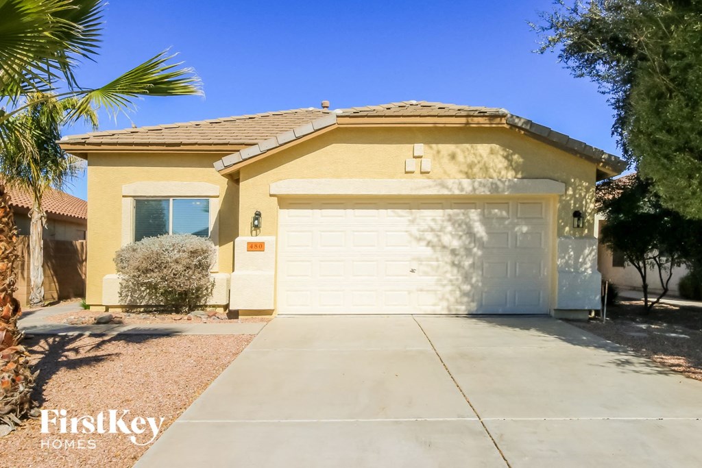 A house with a white garage door and a brown roof.