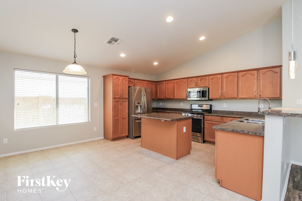 A kitchen with orange cabinets and a white countertop.