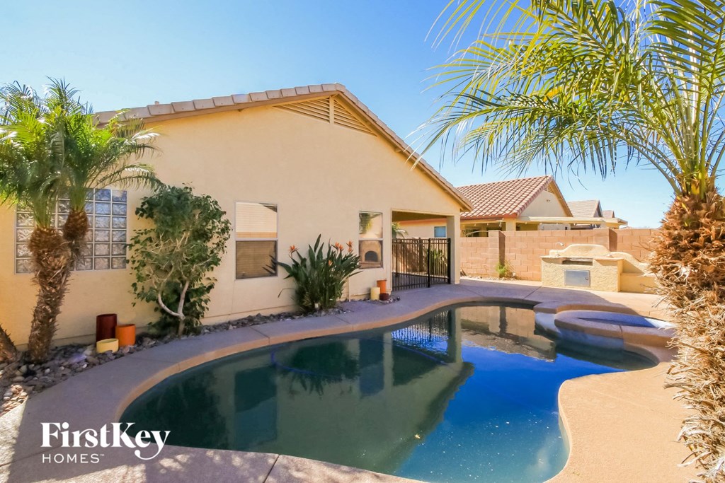 A house with a pool in the backyard.