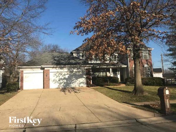 A house with a tree in front of it.