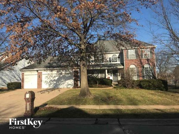 A house with a tree in front of it.