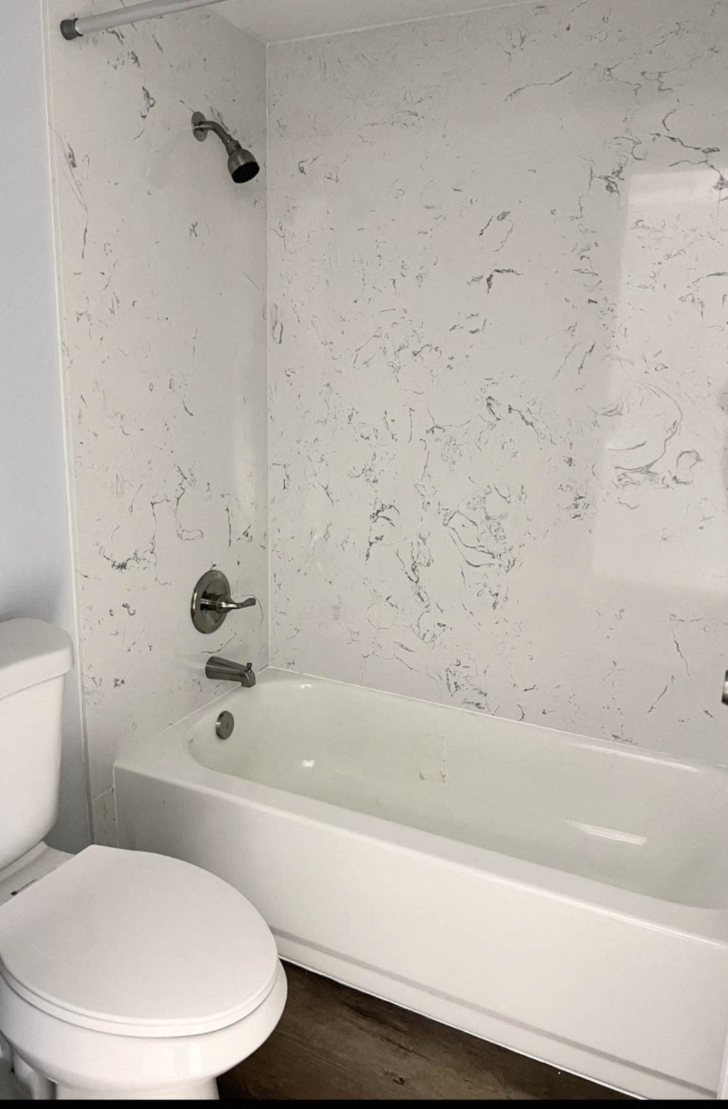 a white bathroom with a toilet and a tub