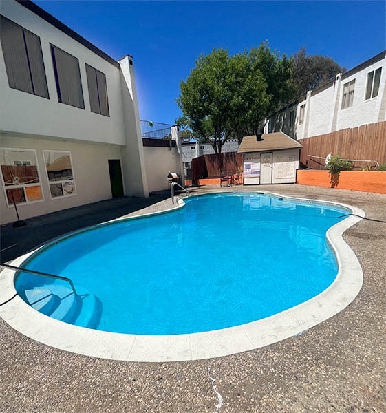a swimming pool in the backyard of a house