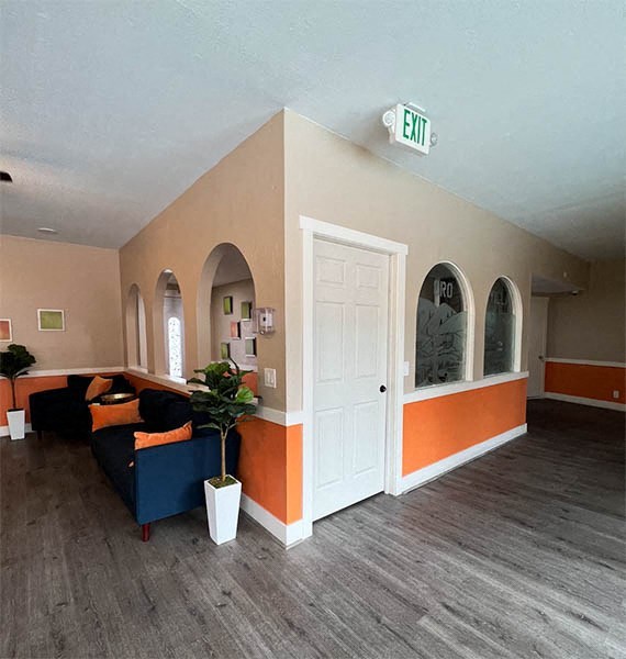 a living room with a couch and a door