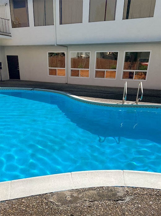 a swimming pool in front of a building