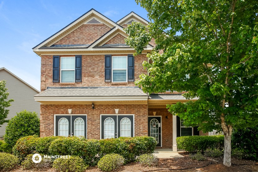 a brick house with a tree in front of it