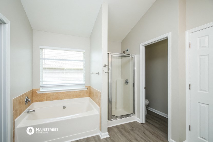 a bathroom with a large tub and a shower