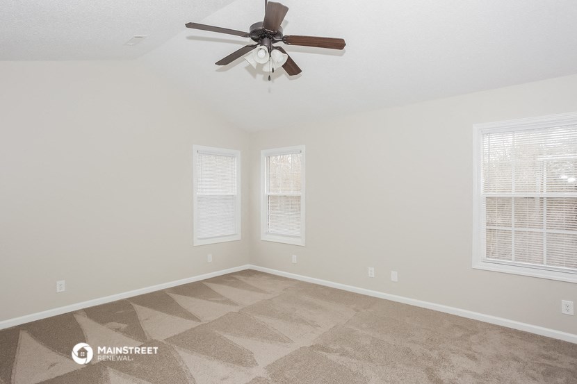the spacious living room of a manufactured home with a ceiling fan