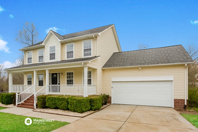 a yellow house with a white garage door