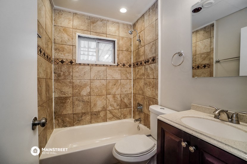 a bathroom with a sink toilet and a bath tub