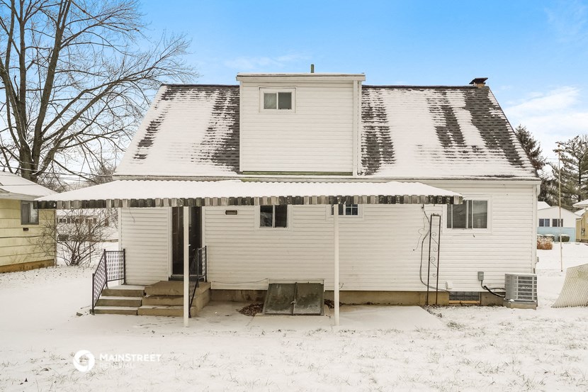 a white house with snow on the roof