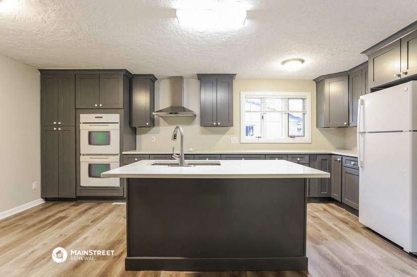 a kitchen with a large island in the middle of it