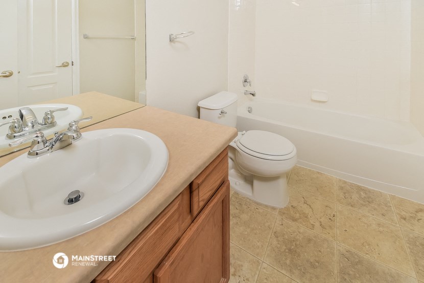 a bathroom with a sink and a toilet and a tub
