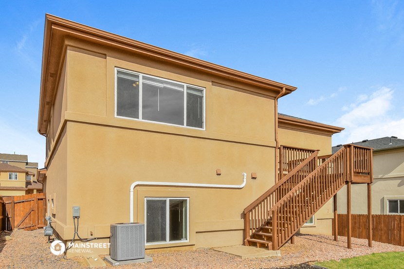 the exterior of a house with a staircase and a large window