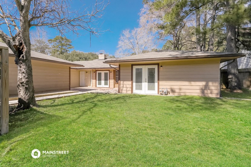 a small house with a lawn and a tree