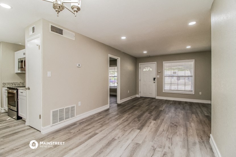 the kitchen and living room are spacious and clean