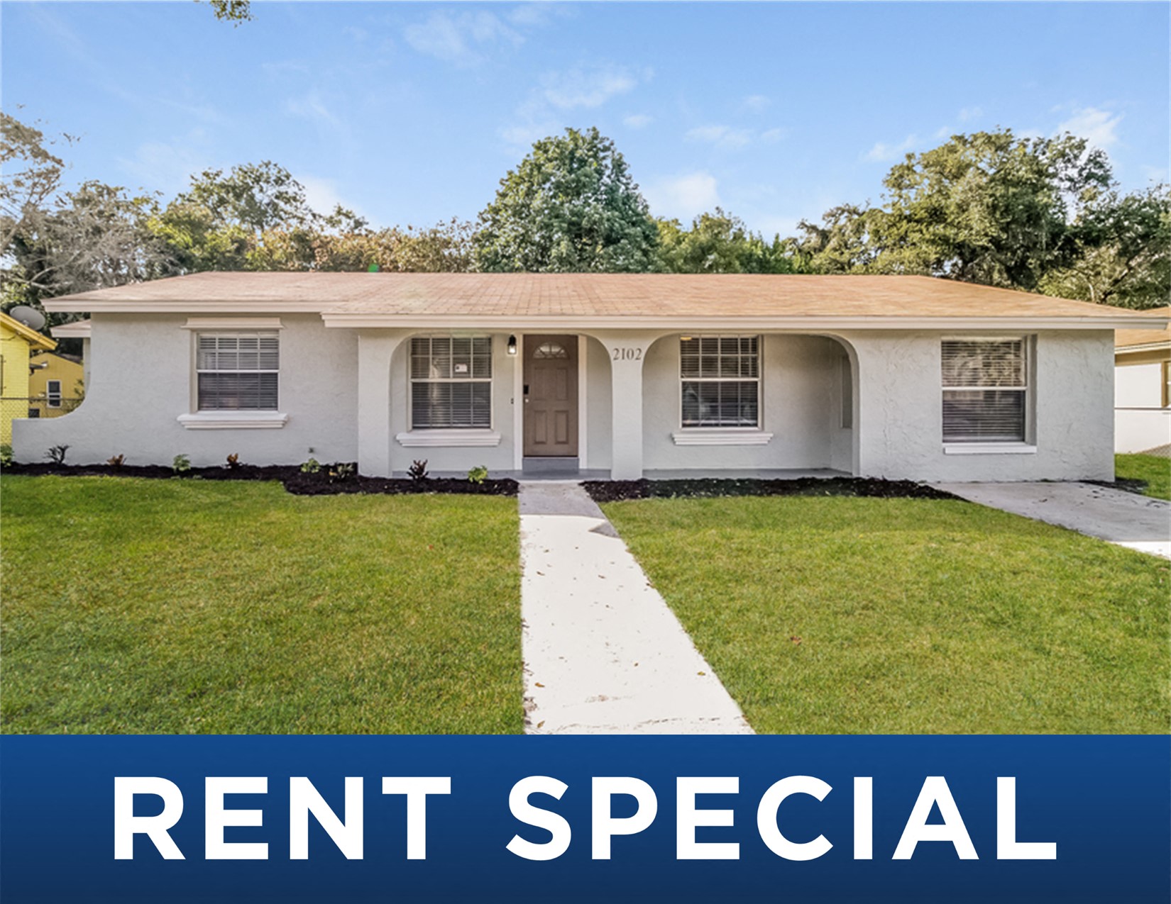 a white house with a lawn and a yard with the words rent special